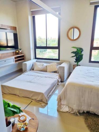 a living room with two beds and a couch at Exclusivo mono para 4 personas in Luque