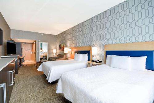 a hotel room with two beds and a kitchen at Home2 Suites By Hilton Livermore in Livermore