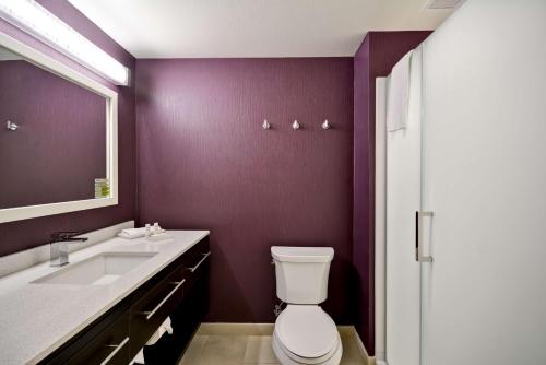 a bathroom with a toilet and a sink and a mirror at Home2 Suites By Hilton Livermore in Livermore