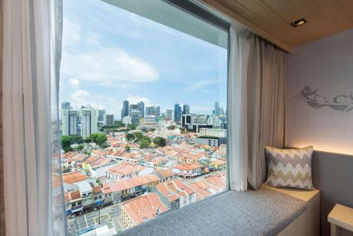 a window with a view of a city at Hilton Garden Inn Singapore Serangoon in Singapore