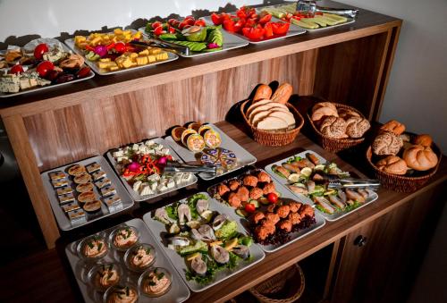 a buffet with many different types of food on display at Helios in Sulina