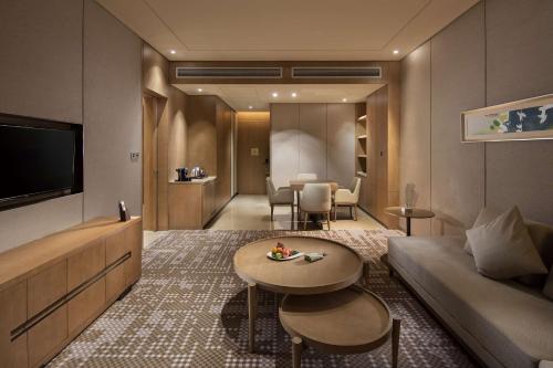 a living room with a couch and a table at DoubleTree By Hilton Xiamen-Haicang in Xiamen