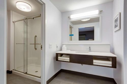 a bathroom with a sink and a shower at Hampton Inn-St. Louis Wentzville, MO in Wentzville