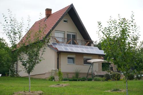 a house with a lot of solar panels on the roof at Vikendica Mali Raj in Čortanovci