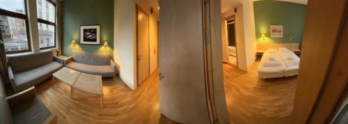 a living room with a couch and a bed in a room at Mitt hotell & apartments in Moss