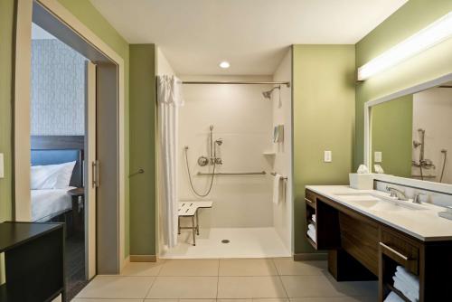 y baño con ducha y lavamanos. en Home2 Suites By Hilton Charles Town en Charles Town