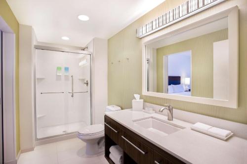a bathroom with a sink and a toilet and a mirror at Home2 Suites By Hilton Oxford in Oxford