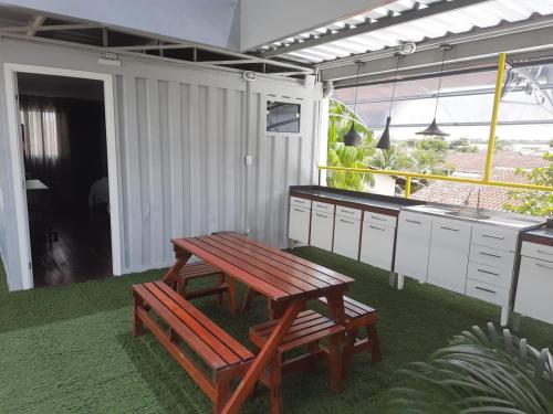 a picnic table and a bench in a kitchen at Aiezza Hotel in Barcarena