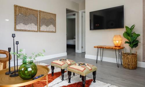 a living room with a table and a tv at La Vie Boheme 1 - Relaxing Retreat w Parking in Miami