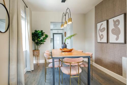 a dining room with a table and pink chairs at La Vie Boheme 1 - Relaxing Retreat w Parking in Miami