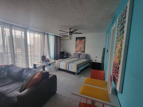 a living room with a bed and a couch at Oceana Trendy Ocean View Condo Hotel in Condado in San Juan
