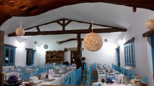 a large dining room with white tables and blue chairs at hotel Piccolo Ranch in Pula