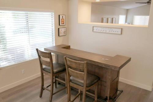 a dining room with a wooden table and chairs at Bright & Fresh Oasis Near Goodyear Ballpark in Goodyear