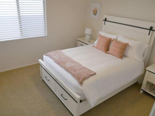 a white bedroom with a large white bed with pillows at Bright & Fresh Oasis Near Goodyear Ballpark in Goodyear