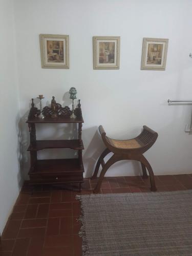 a chair sitting in a room with a white wall at Mzila Forest Creek in Maanhaarrand