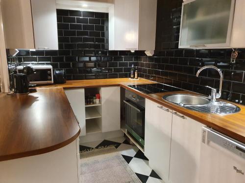 a kitchen with a sink and a counter top at Tina's Apartment in Pori