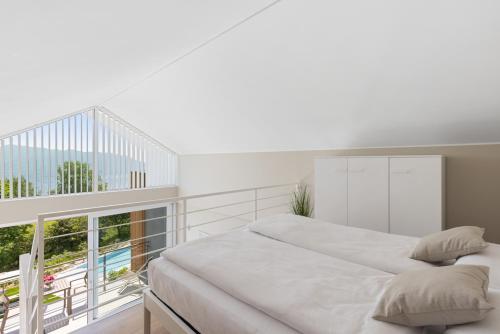 Ένα ή περισσότερα κρεβάτια σε δωμάτιο στο Residence Conca Verde with pool