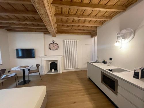 a kitchen and living room with a fireplace at La Dimora del Brocante in Cuneo