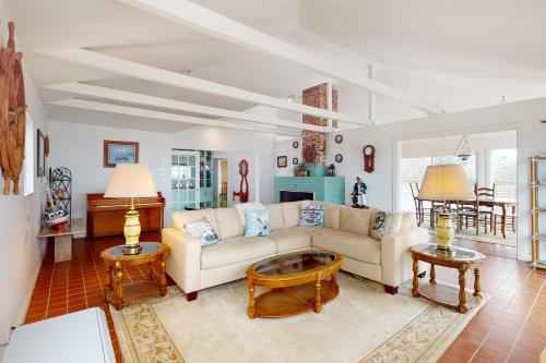 a living room with a couch and two tables at Saddle Point Estate in Elk