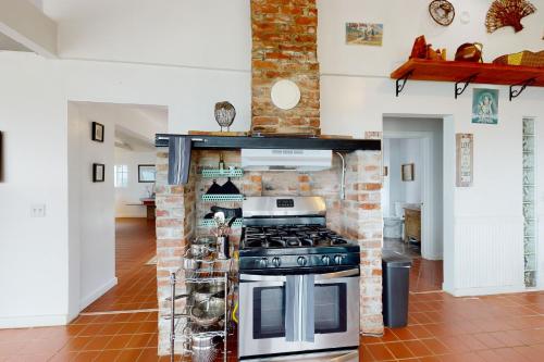 a kitchen with a stove and a brick wall at Saddle Point Estate in Elk