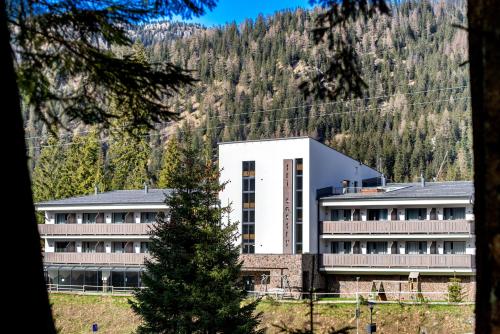 a building in front of a mountain at Tri sestry in Demanovska Dolina