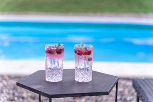 two vases with fruit in them sitting on a table at Fruska Pool House in Sremska Kamenica