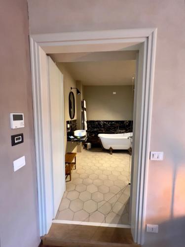 a view of a bathroom with a tub and a sink at MiaClara Relais in Alba