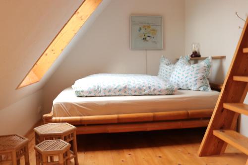 a bedroom with a bed with blue pillows on it at Heimaey, Ljósheimar in Passee