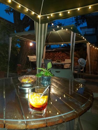 a table with a drink on it with an umbrella at Вила Радеви in Obzor