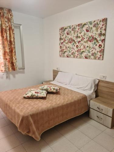 a bedroom with a bed with two pillows on it at Allotjament dels Ports in La Senia