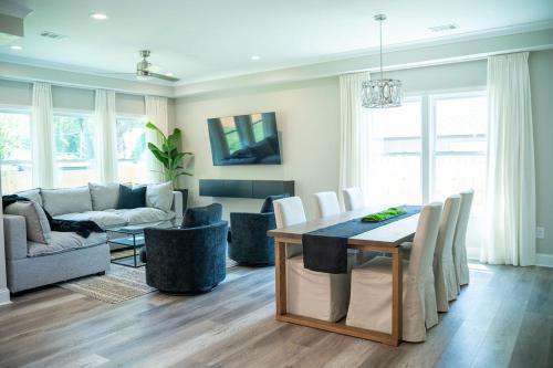 a dining room and living room with a table and chairs at BRAND NEW: Urban Oasis 5 min from Mercedes Benz in Atlanta