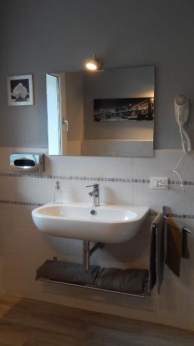 a bathroom with a white sink and a mirror at Flyingaway in Borso del Grappa
