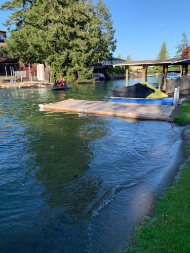 a boat ramp on a river with people in it at Lake Tapps Bungalow in Dieringer