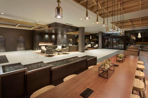 a lobby with a long table and chairs at Doubletree By Hilton Greeley At Lincoln Park in Greeley
