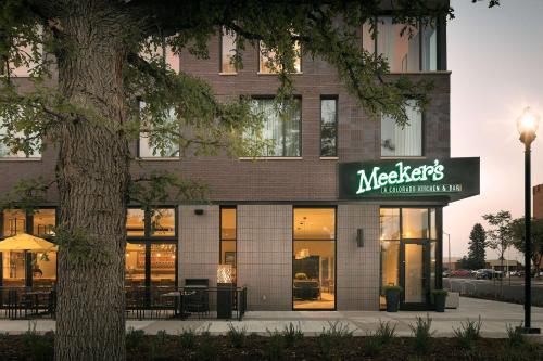 a building with a meerkats sign in front of it at Doubletree By Hilton Greeley At Lincoln Park in Greeley