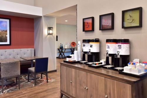 a restaurant with a counter with wine bottles on it at Hampton Inn and Suites at Wisconsin Dells Lake Delton in Wisconsin Dells