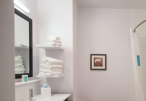 a bathroom with a sink and a mirror and towels at Hampton Inn and Suites at Wisconsin Dells Lake Delton in Wisconsin Dells