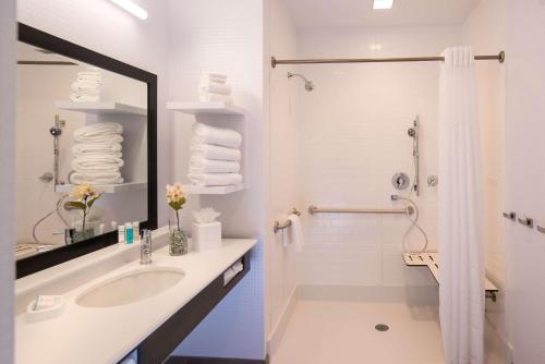 a white bathroom with a sink and a shower at Hampton Inn and Suites at Wisconsin Dells Lake Delton in Wisconsin Dells