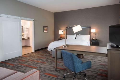 a hotel room with a bed and a desk and a bed at Hampton Inn and Suites at Wisconsin Dells Lake Delton in Wisconsin Dells
