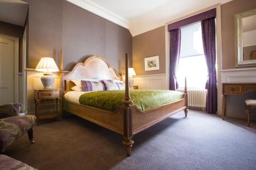 A bed or beds in a room at Muckrach Country House Hotel 