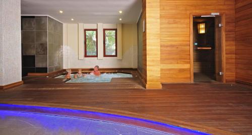 two people swimming in a hot tub in a house at Samara Hotel Bodrum Ultra All Inclusive in Torba