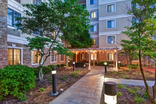 a courtyard in front of a building with lights at Homewood Suites by Hilton Aurora Naperville in Aurora