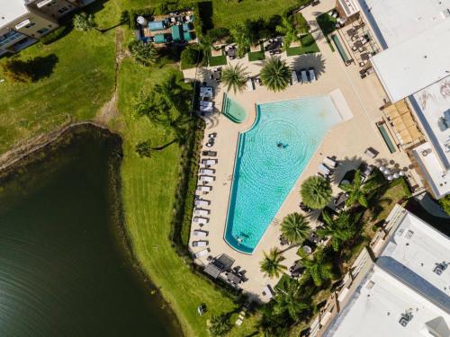an aerial view of a swimming pool with a resort at 3212 Magic Village 8 guests lakefront 8 min Disney in Orlando