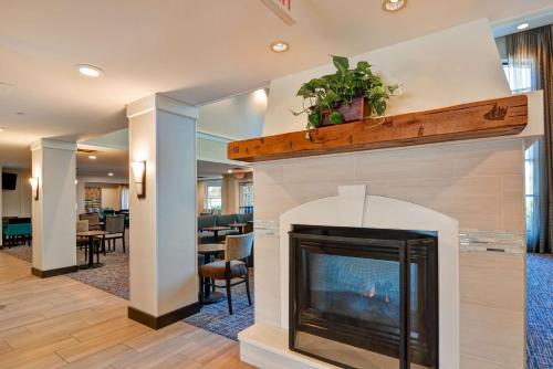a fireplace in a living room with a fire place at Homewood Suites by Hilton Aurora Naperville in Aurora