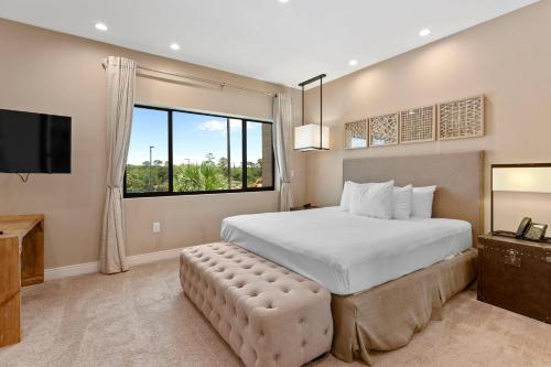a bedroom with a large bed and a large window at 7564 Magic Village luxury jacuzzi bbq 6min Disney & 192 in Orlando