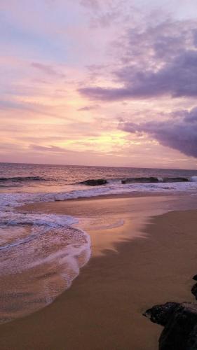 a beach with the ocean and a cloudy sky at Case vacanze LULU in Seclì