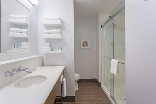 a white bathroom with a sink and a shower at Hampton Inn Fort Lauderdale Pompano Beach in Pompano Beach