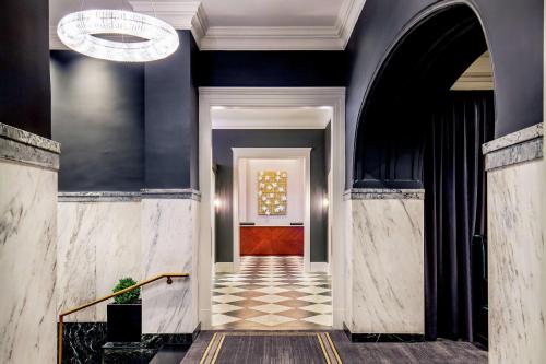 a hallway with blue walls and a red door at The Virginian Lynchburg, Curio Collection By Hilton in Lynchburg
