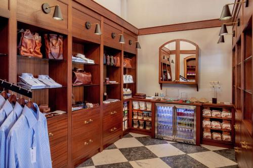 a dressing room with wooden cabinets and a mirror at The Virginian Lynchburg, Curio Collection By Hilton in Lynchburg