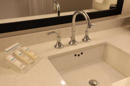 a kitchen counter with a sink and a faucet at Hilton Garden Inn Austin Airport in Austin